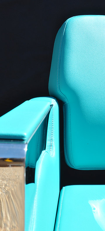 Salon chair arm, seat and stitching details upholstered in vinyl
