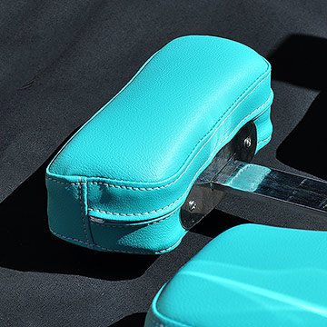 Vinyl upholstered salon chairs, headrest and stitching detail